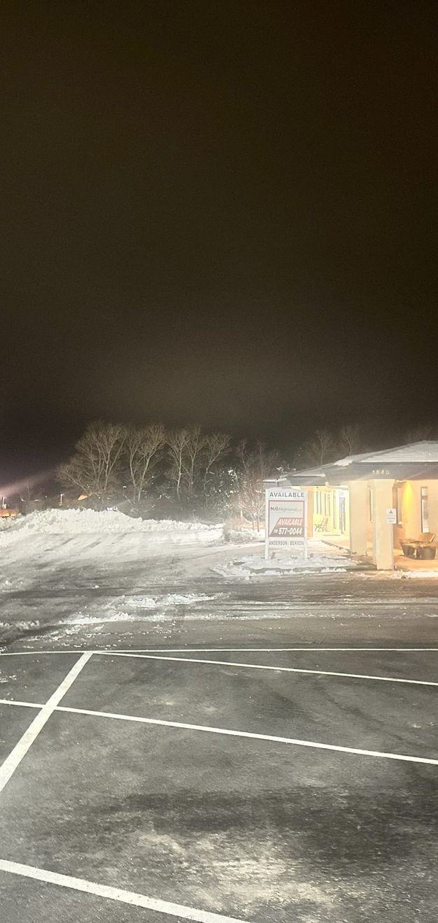 Freshly plowed commercial parking lot under the lights in Monument